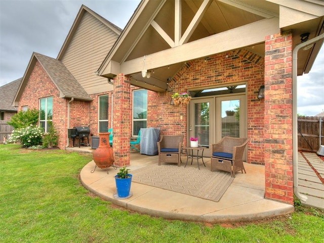 view of patio / terrace with fence and a grill