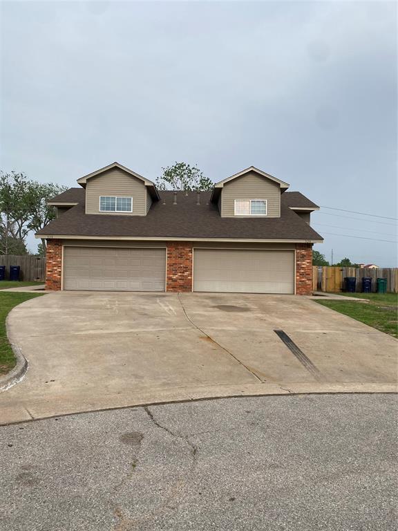 view of front facade with fence, a shingled roof, concrete driveway, and an attached garage