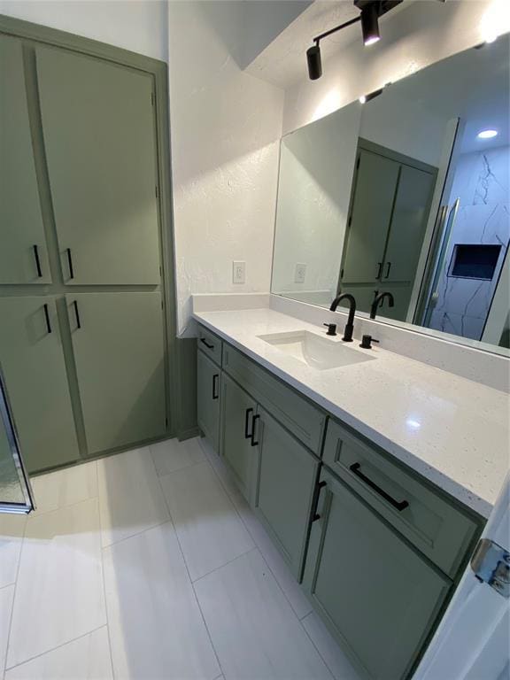bathroom with tile patterned flooring and vanity
