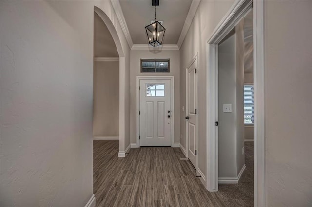 11608 NW 104th St, Yukon, OK 73099 - entryway featuring baseboards, arched walkways, an inviting chandelier, and crown molding