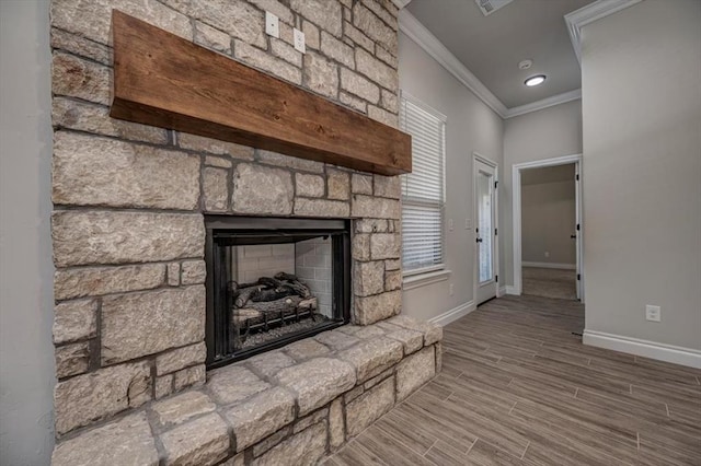 11608 NW 104th St, Yukon, OK 73099 - unfurnished living room featuring baseboards, wood finished floors, a stone fireplace, and crown molding