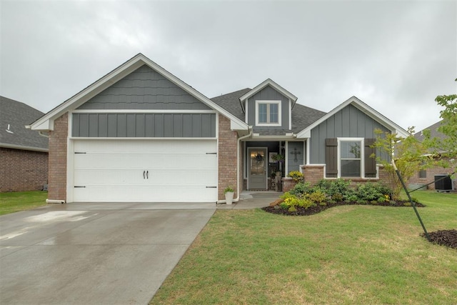 craftsman inspired home with a front lawn, cooling unit, brick siding, board and batten siding, and an attached garage