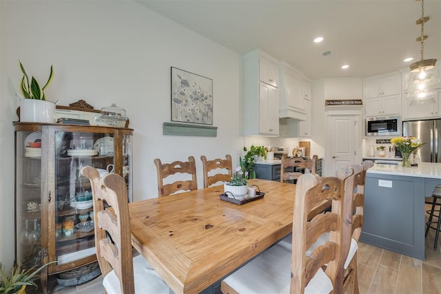 dining room featuring recessed lighting, visible vents, and light wood-type flooring