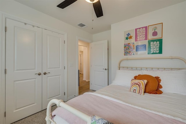 bedroom featuring visible vents, ceiling fan, and a closet