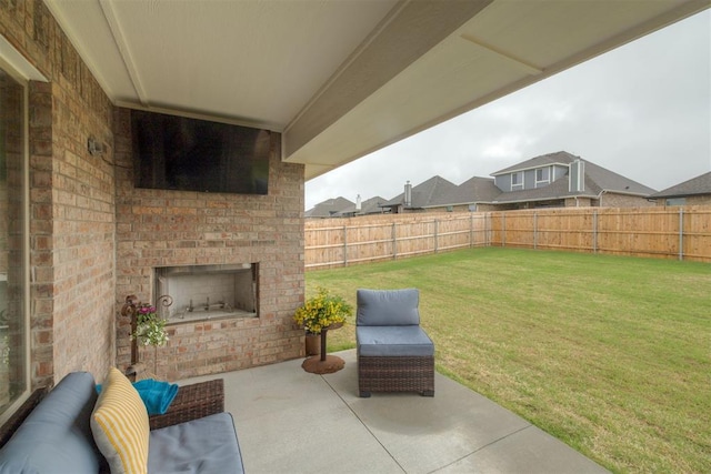 view of patio featuring a fenced backyard and an outdoor brick fireplace