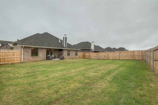 view of yard with a fenced backyard and a patio area