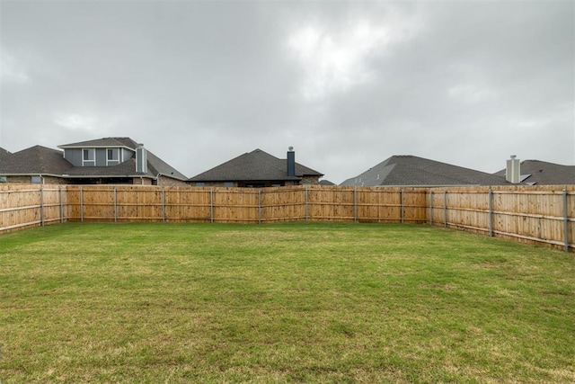 view of yard with a fenced backyard