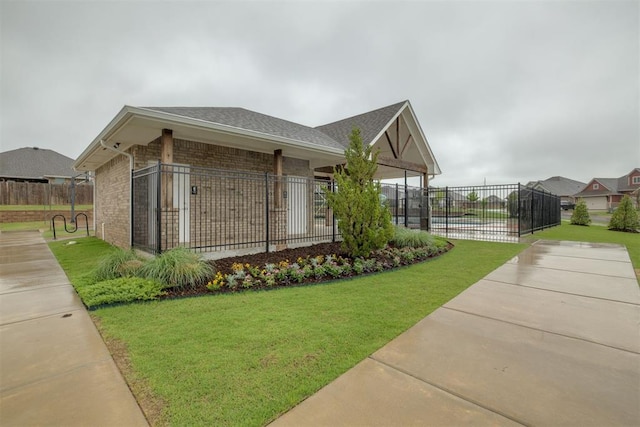 view of property's community with a lawn and fence