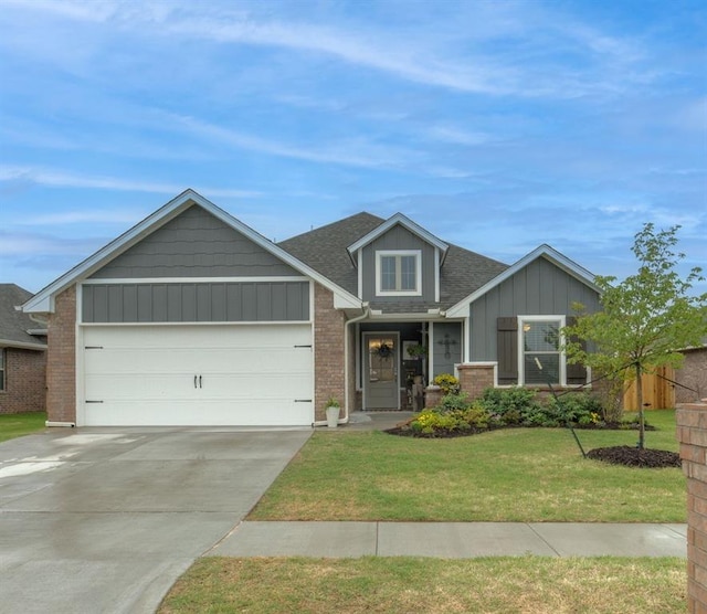 9304 NW 89th St, Yukon, OK 73099 - view of front of property with board and batten siding, driveway, a garage, a front yard, and brick siding