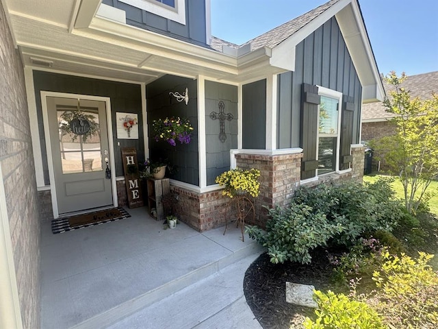 9304 NW 89th St, Yukon, OK 73099 - entrance to property featuring board and batten siding, roof with shingles, and covered porch