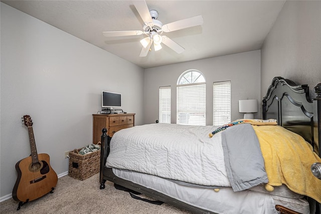 carpeted bedroom featuring baseboards and ceiling fan