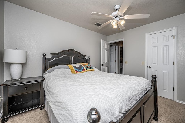 bedroom featuring light colored carpet, ceiling fan, and visible vents