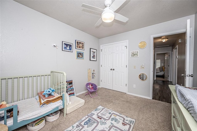 carpeted bedroom featuring a closet, a ceiling fan, and baseboards