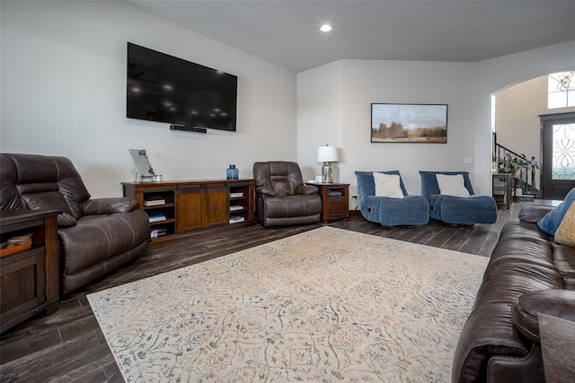 living area with recessed lighting, arched walkways, and dark wood finished floors