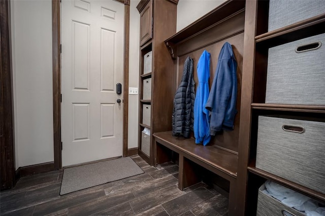 mudroom featuring dark wood-style flooring and baseboards