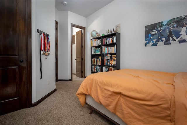 bedroom with carpet floors and baseboards