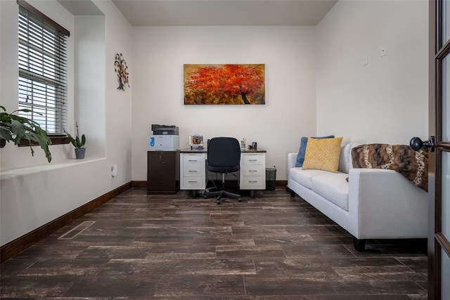 home office with baseboards, wood finished floors, and visible vents