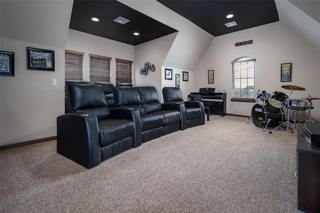 carpeted home theater room with baseboards, visible vents, and lofted ceiling