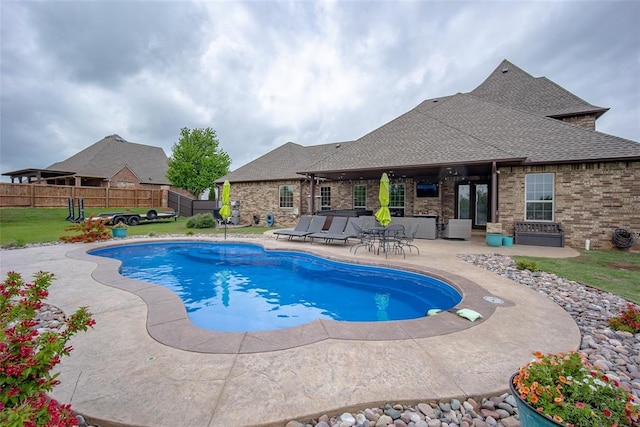view of pool with a lawn, a patio, fence, and a fenced in pool