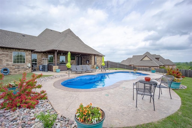 view of pool featuring a yard, a patio, a fenced in pool, and a fenced backyard