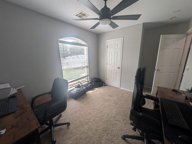 carpeted home office featuring ceiling fan and visible vents