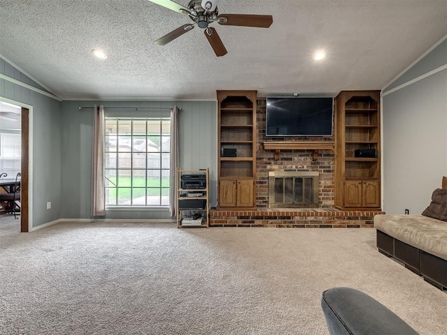 living room with carpet floors, a ceiling fan, crown molding, and a brick fireplace