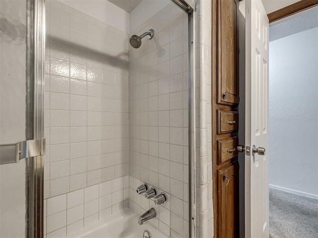 full bath with baseboards and shower / washtub combination