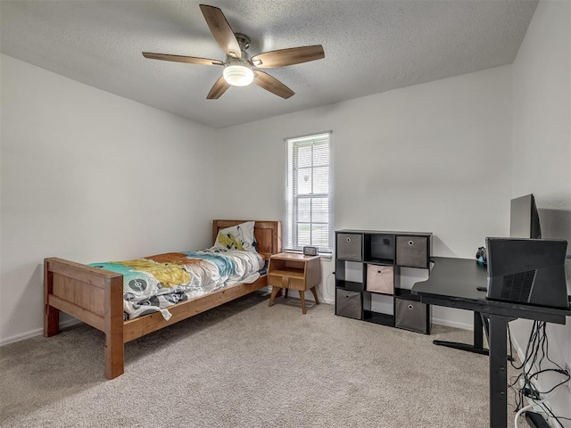 carpeted bedroom with baseboards, a textured ceiling, and ceiling fan