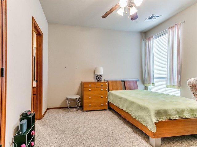 bedroom featuring carpet floors, baseboards, a ceiling fan, and visible vents