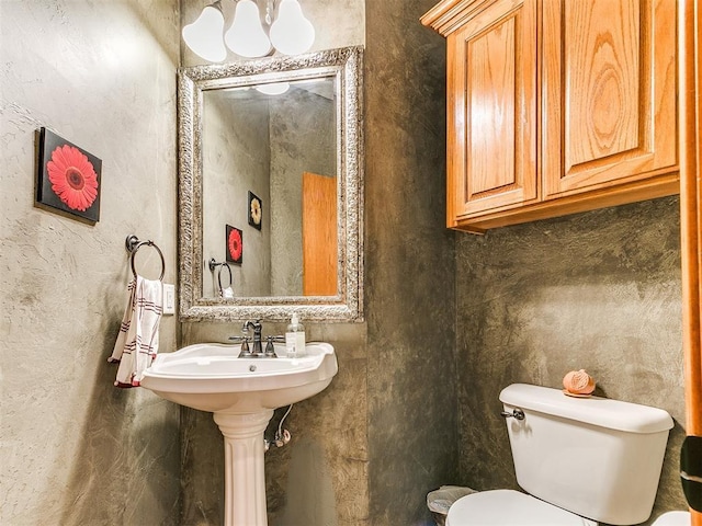 half bathroom featuring toilet