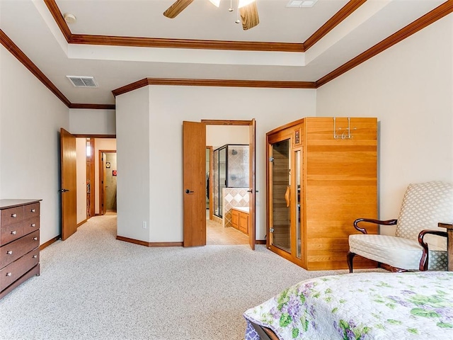 bedroom with visible vents, ornamental molding, baseboards, a raised ceiling, and carpet