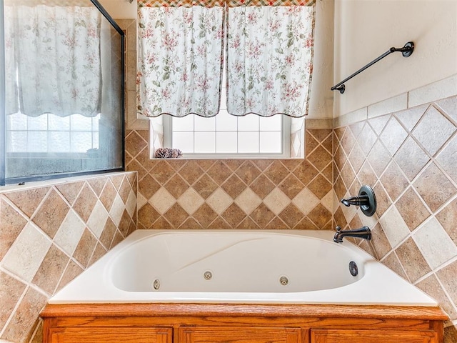 bathroom with a jetted tub, a shower, and a healthy amount of sunlight