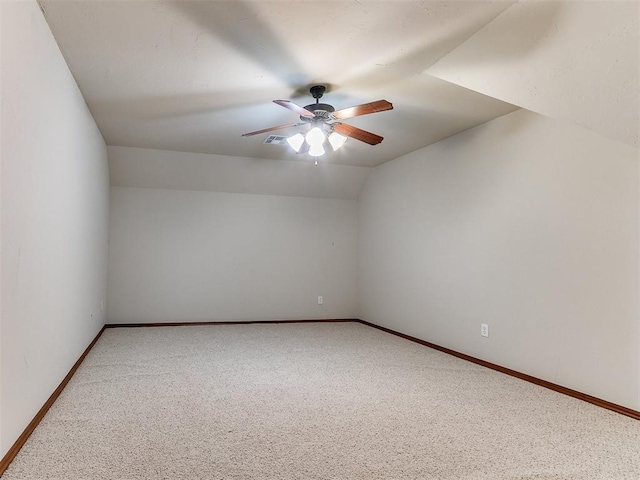 spare room with carpet floors, ceiling fan, baseboards, and lofted ceiling