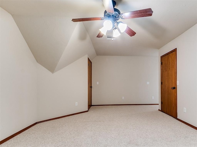 bonus room featuring ceiling fan, carpet flooring, visible vents, and lofted ceiling