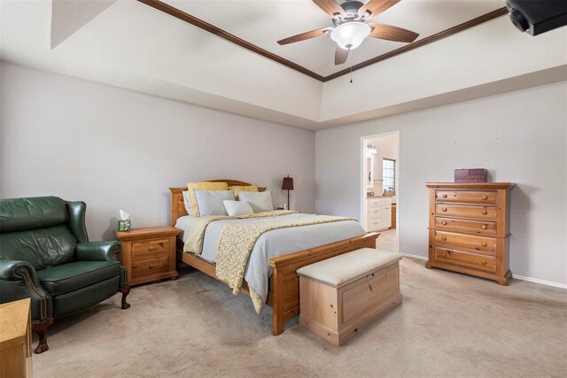 bedroom featuring crown molding, baseboards, ceiling fan, light colored carpet, and connected bathroom