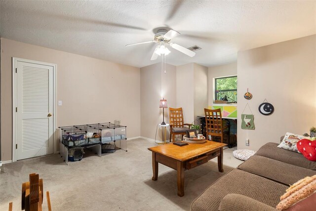 carpeted living room featuring visible vents, a ceiling fan, and baseboards