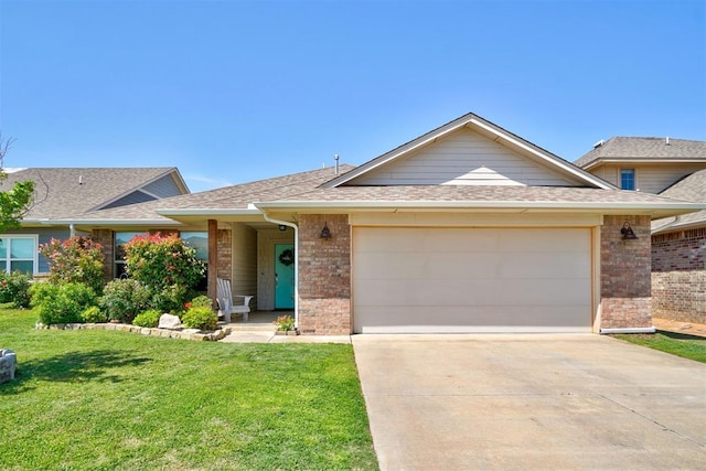 view of front facade with brick siding, a front lawn, an attached garage, and concrete driveway