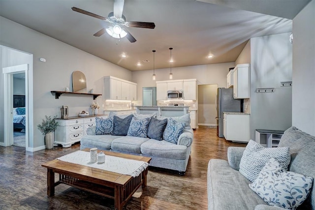 living room featuring baseboards, a ceiling fan, dark wood finished floors, and recessed lighting