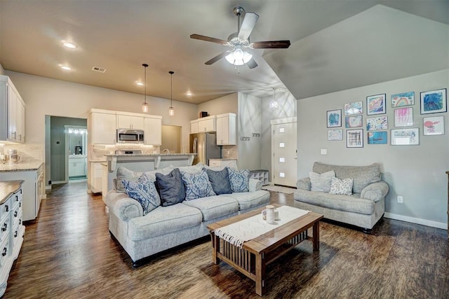 living area featuring a ceiling fan, visible vents, dark wood finished floors, baseboards, and recessed lighting