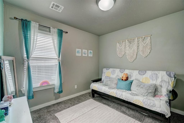 carpeted living room with visible vents and baseboards