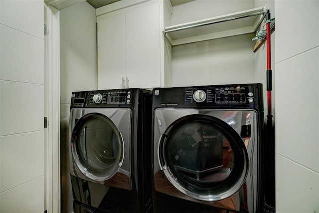 laundry area with cabinet space and separate washer and dryer