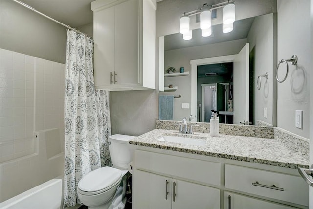 full bath featuring vanity, shower / bath combo with shower curtain, and toilet