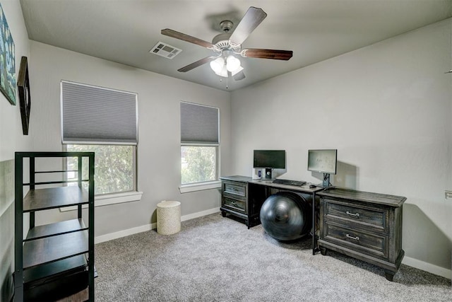 carpeted office featuring visible vents, baseboards, and ceiling fan