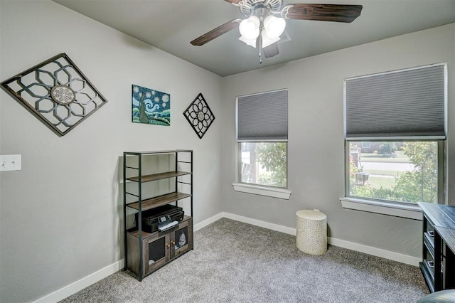 home office featuring carpet floors, baseboards, and a ceiling fan
