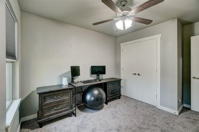 office space with carpet floors, a ceiling fan, and baseboards