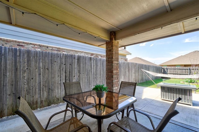 view of patio with a fenced backyard and outdoor dining space