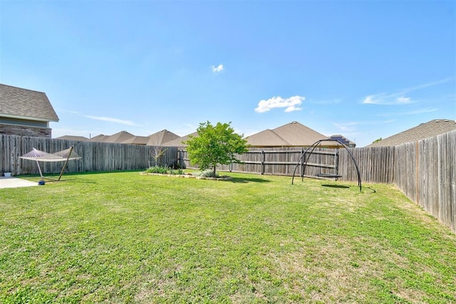 view of yard with a fenced backyard