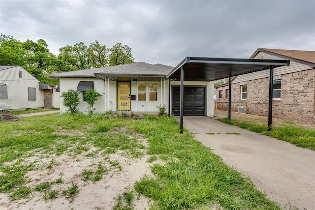 view of front of property with a garage, driveway, and a carport