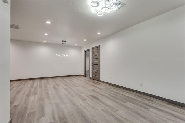 spare room with baseboards, recessed lighting, light wood-style flooring, and visible vents
