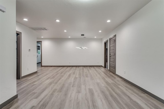 unfurnished room featuring recessed lighting, light wood finished floors, baseboards, and visible vents